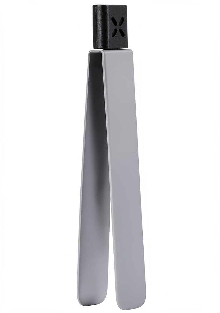 PAX stainless steel tongs placed on a wooden kitchen counter beside a salad bowl